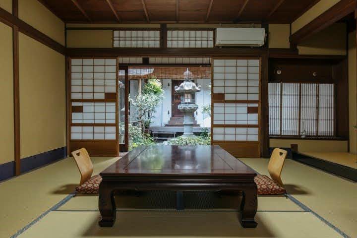 Toshiharu Ryokan with a spacious tatami room centered on a low lacquer table.