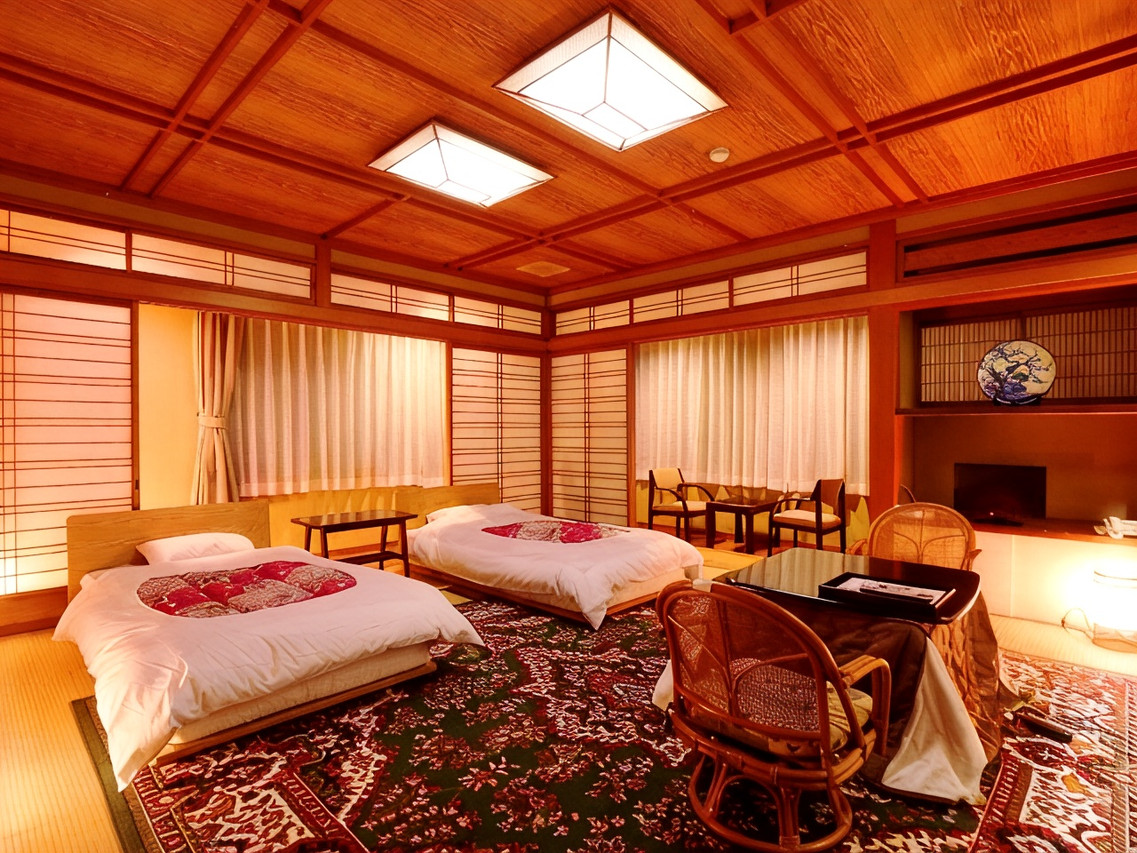 A traditional room is arranged with low tables and bedding.