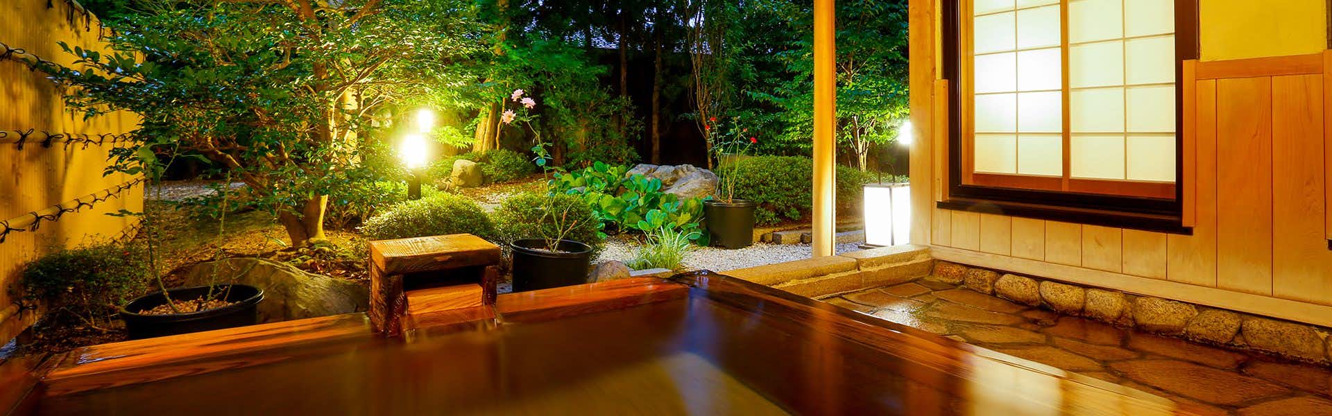 Kaikatei Hanagozen with a private bath overlooking a lantern-lit garden.