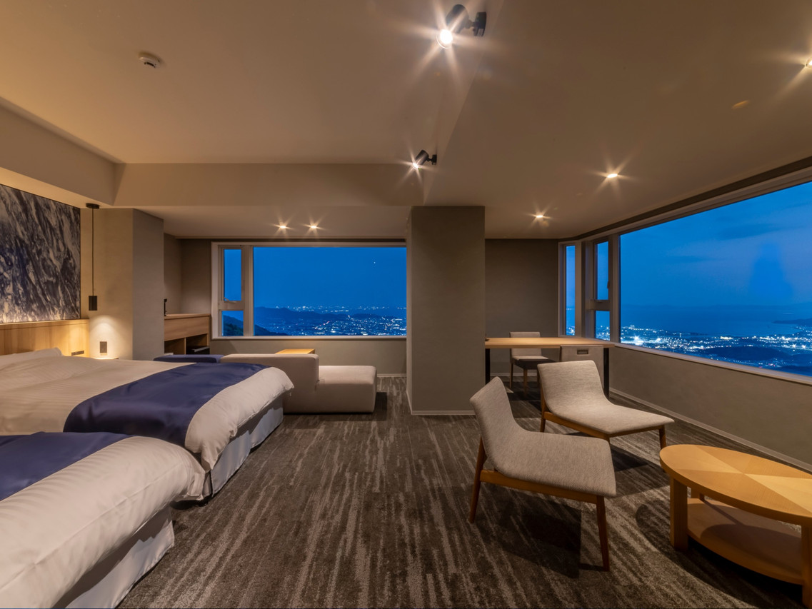 A bright room opens to a sweeping coastal view.
