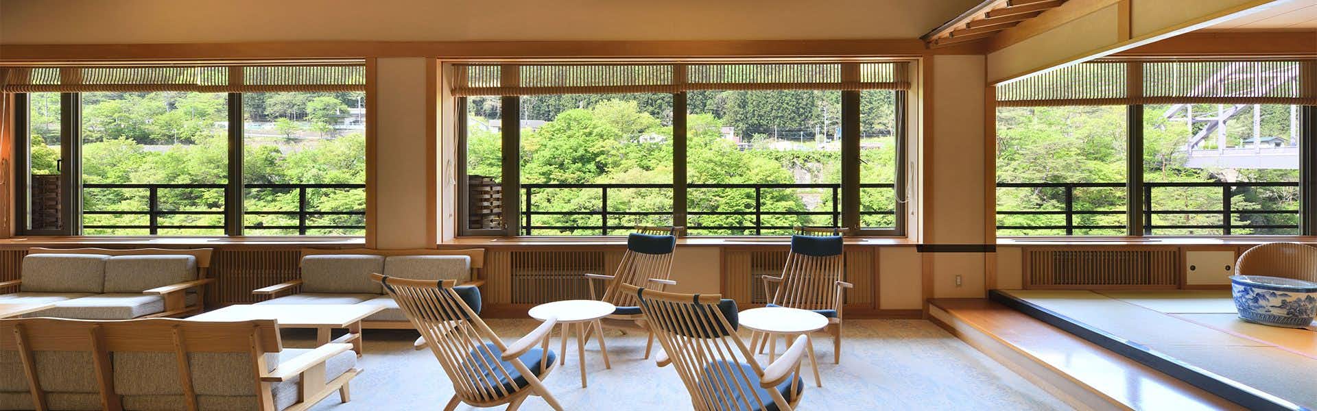 Touryu-kan with a bright lounge overlooking wooded valleys through broad windows.