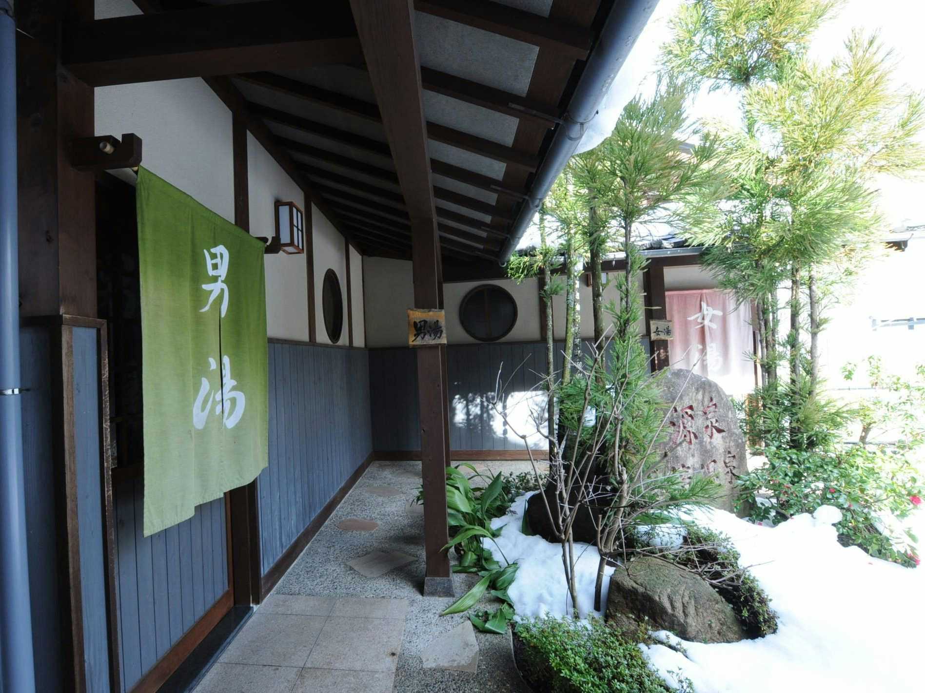 Iwataki Onsen Hotel Kirakuya with the bath entrance framed by traditional hanging curtains.