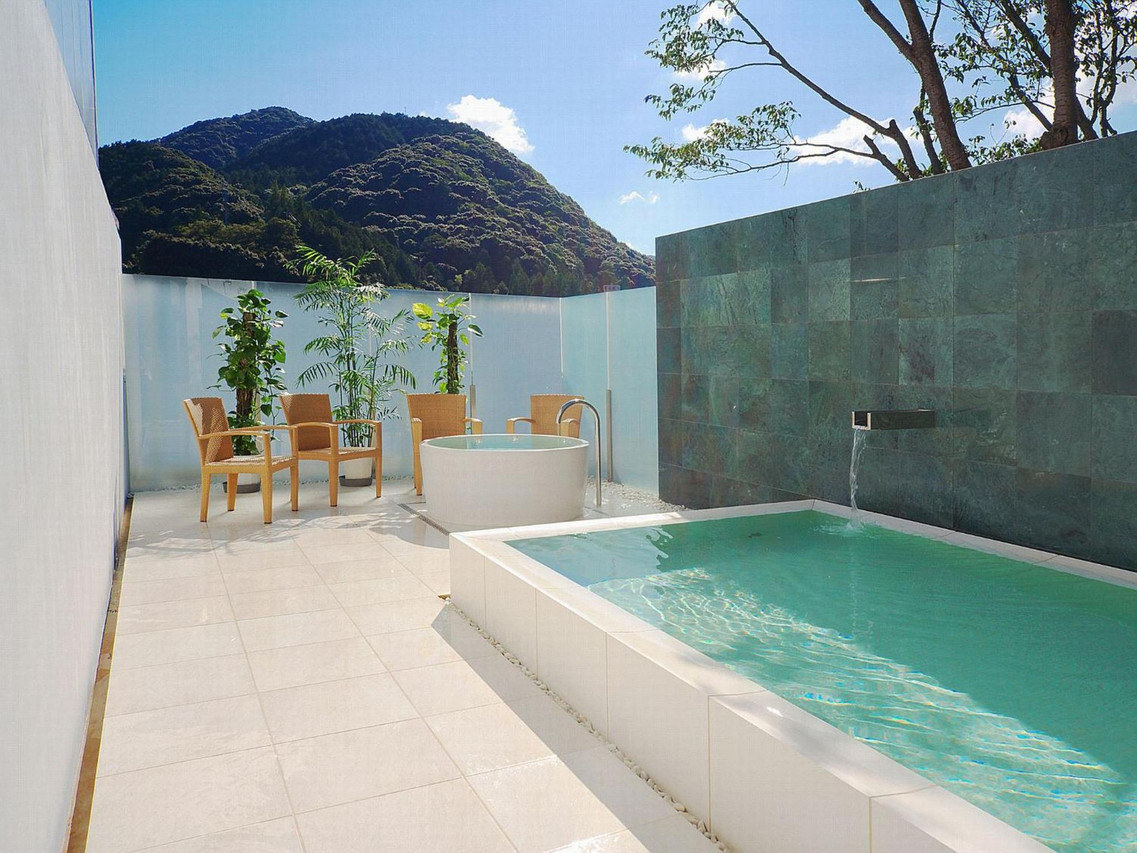 Open-air bath beside a mountain view.