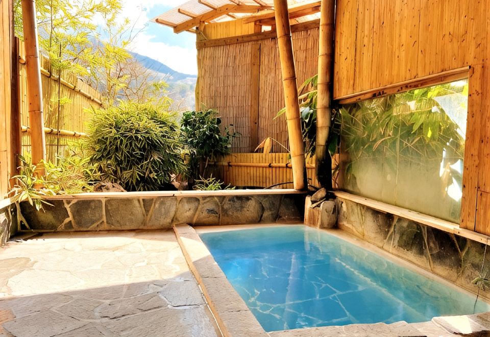A private bath beside a bamboo screen.