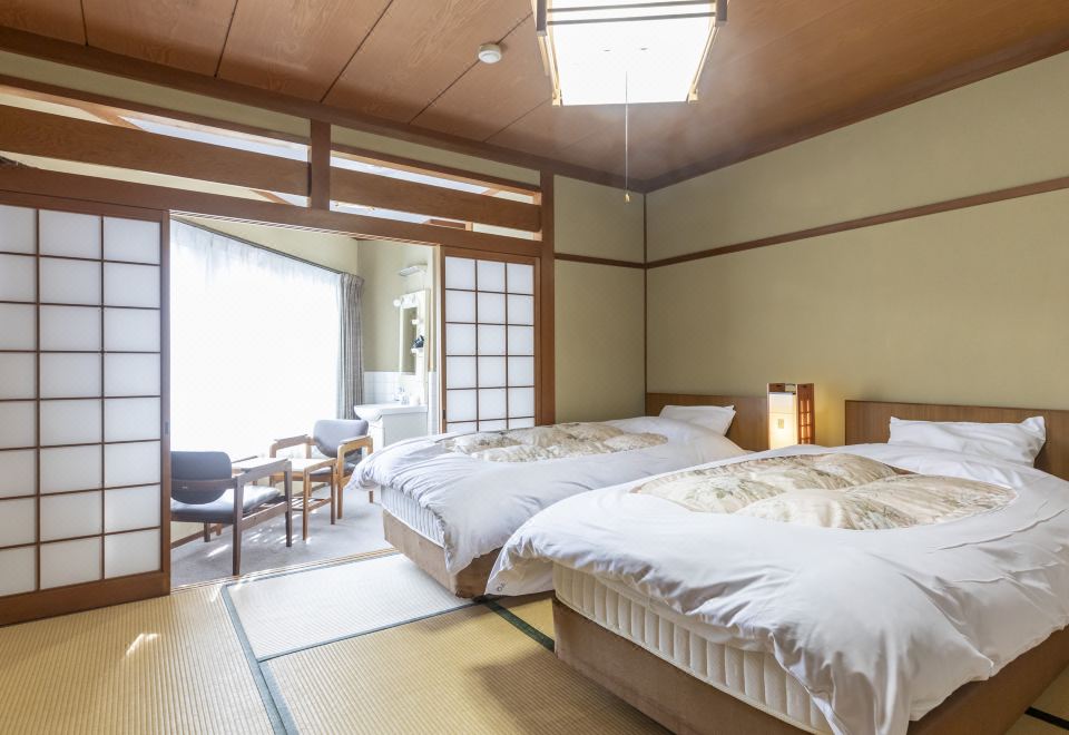A Japanese-style room with beds and a garden view.