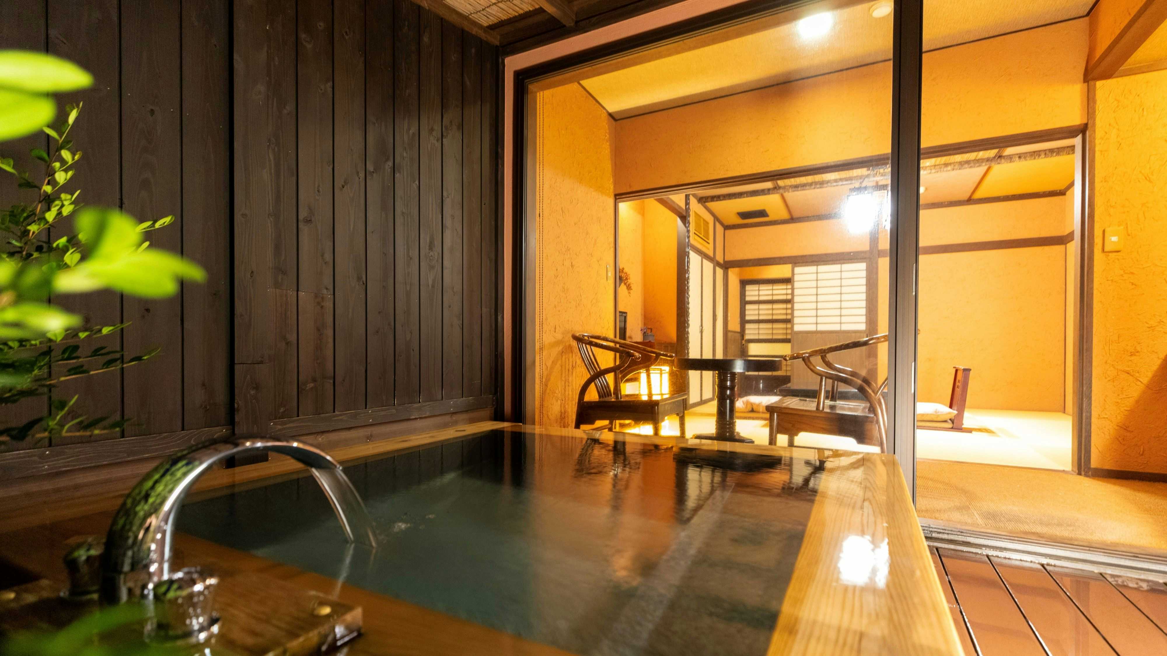 Omoide Nojinde with a guest room opening onto a private terrace bath at dusk.