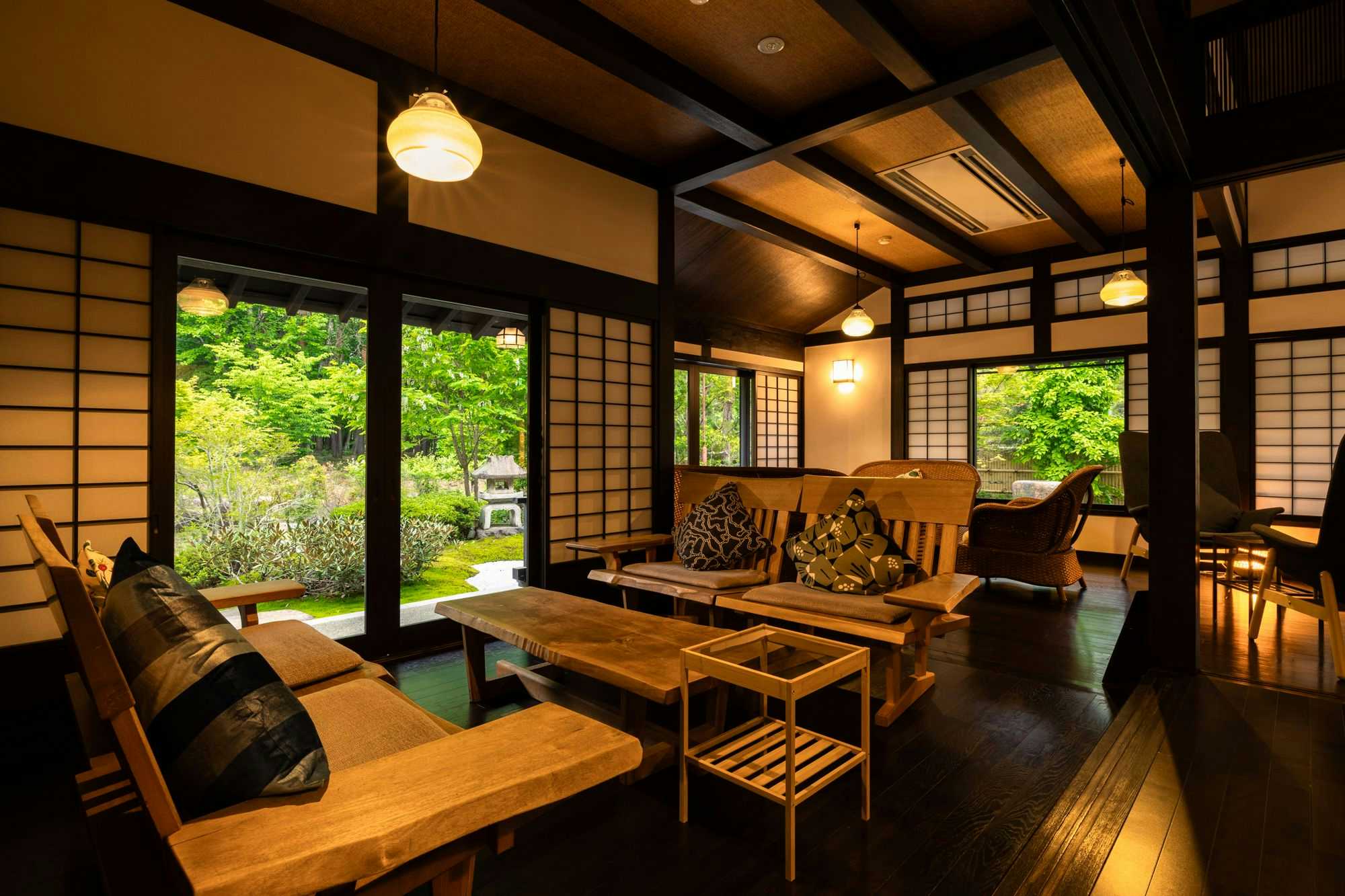 Omachi Onsenkyo Ryoan Kawaki with a timber lounge with patterned chairs and garden views.