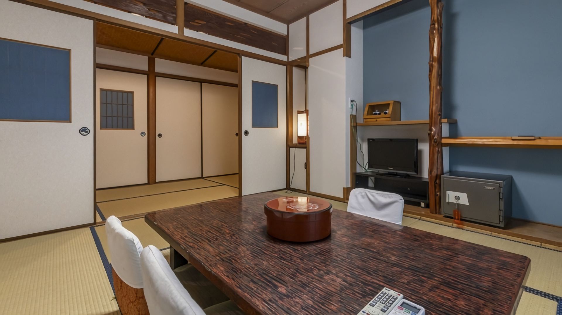 A traditional room with a low table and blue accent wall.