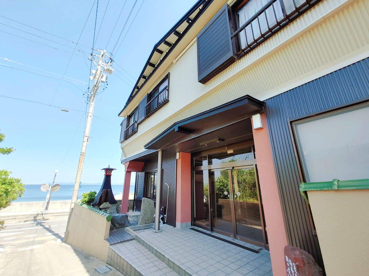 Gifuya Ryokan: The street entrance with glass doors and dark timber trim.
