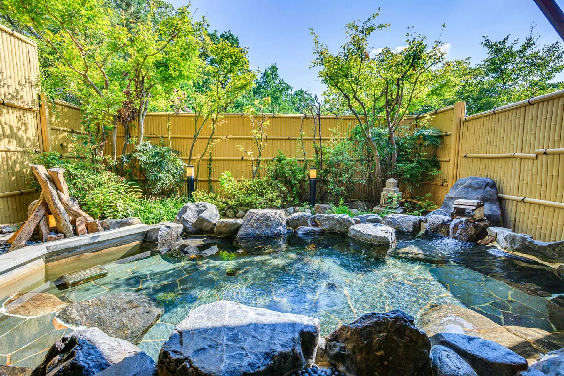 Nara Manyo Wakakusa no Yado Mikasa with an open-air rock bath surrounded by garden greenery.