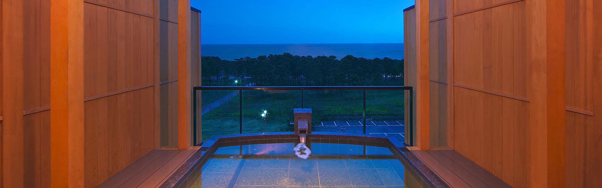 Sasayu Inn by the Sea with a private open-air bath facing the distant coastline.