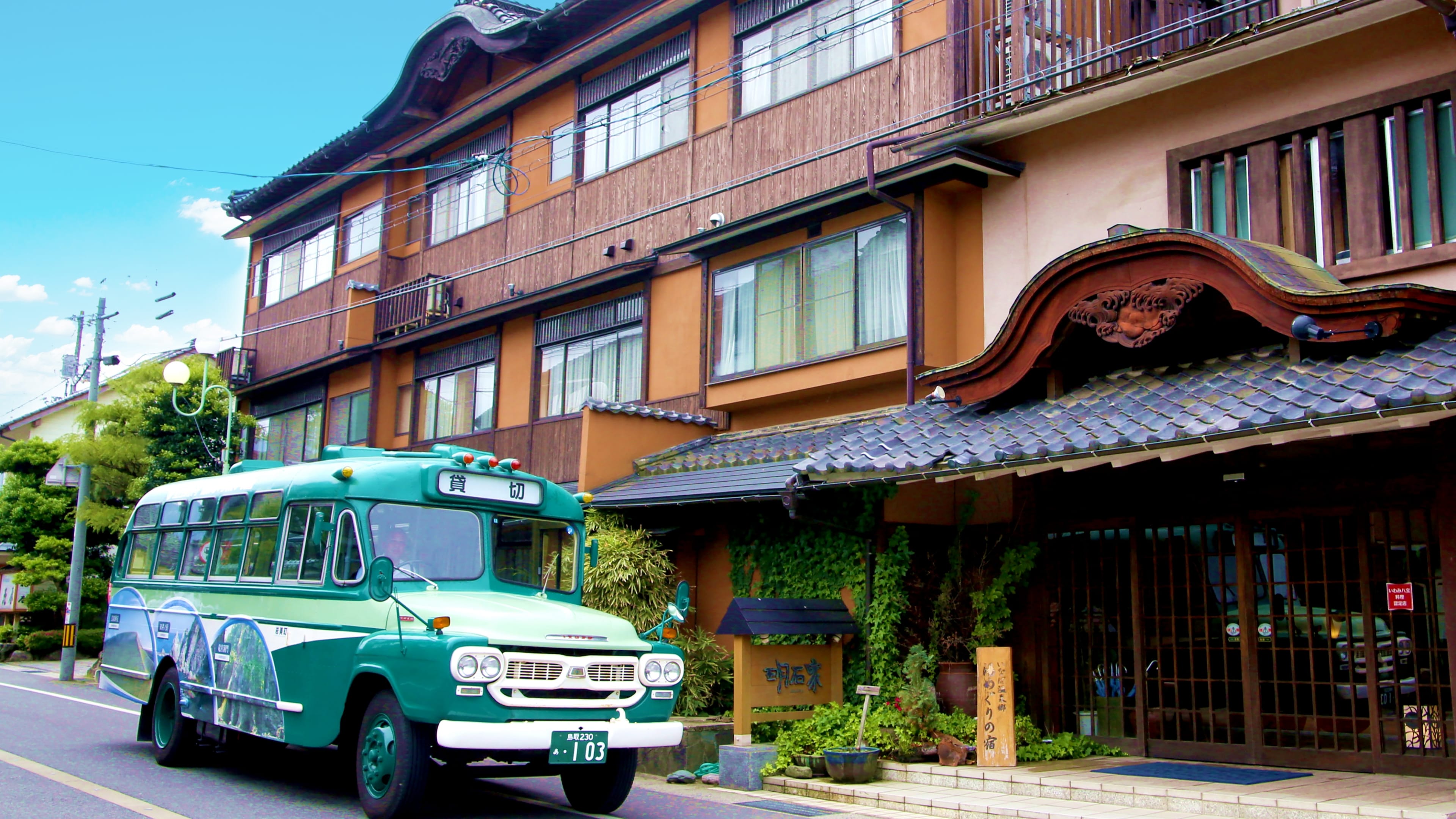 Traditional building with a bus at the entrance.