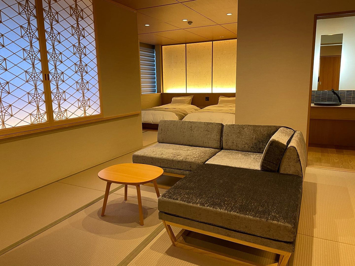 A quiet lounge opens toward a garden and bath.