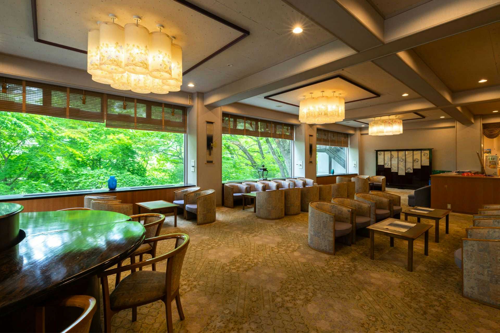 Ginshotei Awashima with a spacious lobby lounge with chandeliers and garden windows.