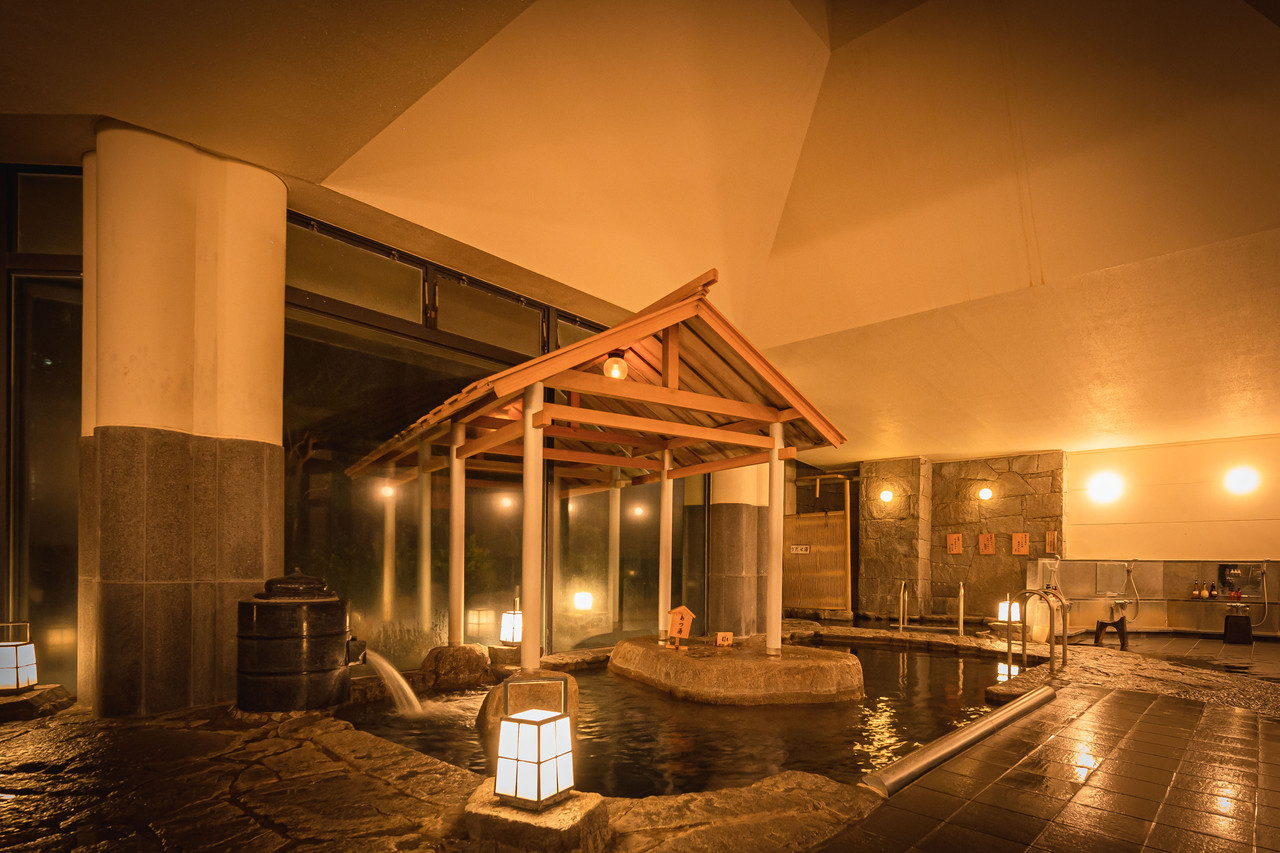 Indoor bath with a water feature.