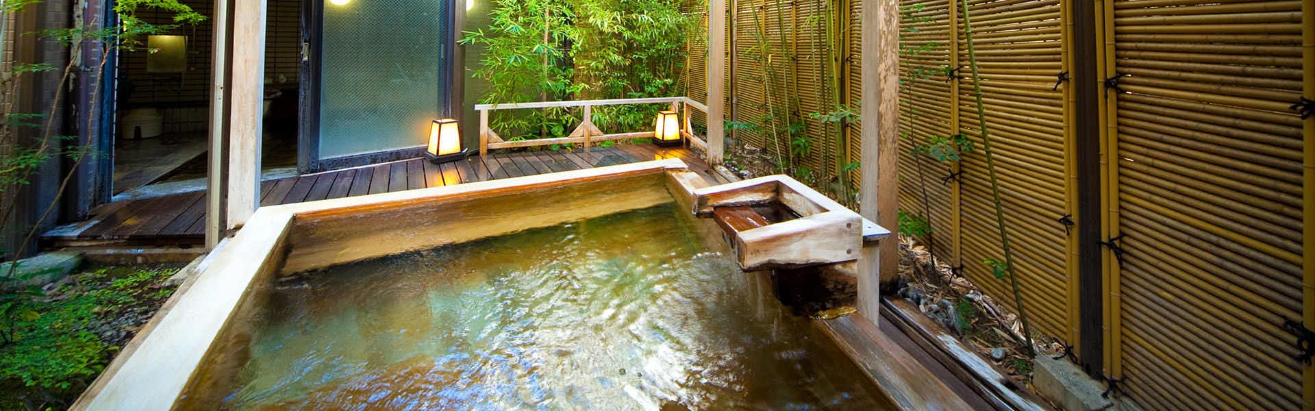 Yufuin Kahori no Sato Hanamura with a private rectangular bath enclosed by bamboo screens.