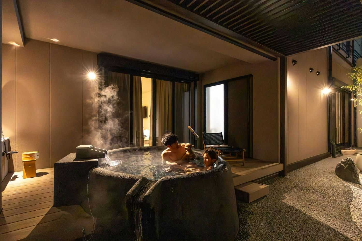 Komatsuya Hachinobo with a private bath with a steaming ceramic teapot on the rim.