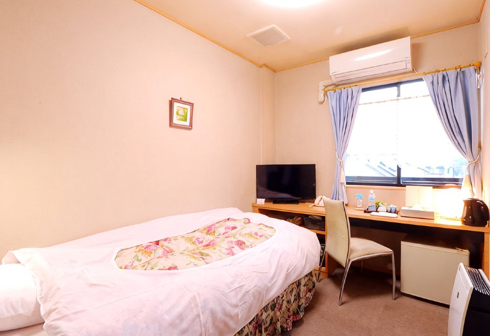 Guest room with a bed and desk.