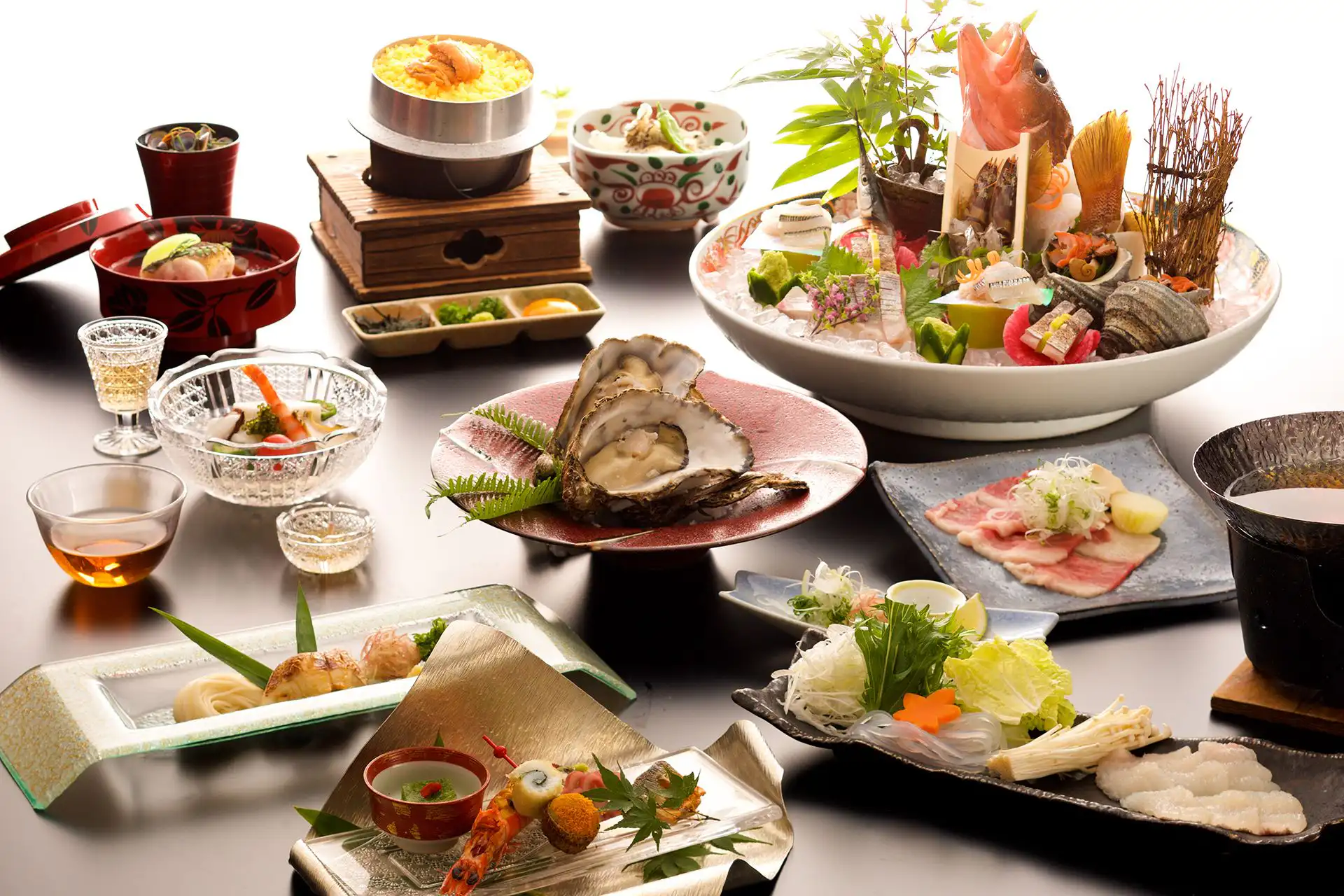 Miyajima Grand Hotel Arimoto with this scene, where its dinner table presents fish, shellfish and many small dishes.