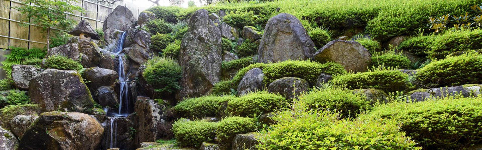 Irori Kaiseki and Juhyo Inn Fudo Onsen Hanabishi with a mossy rock garden with a small cascading waterfall.