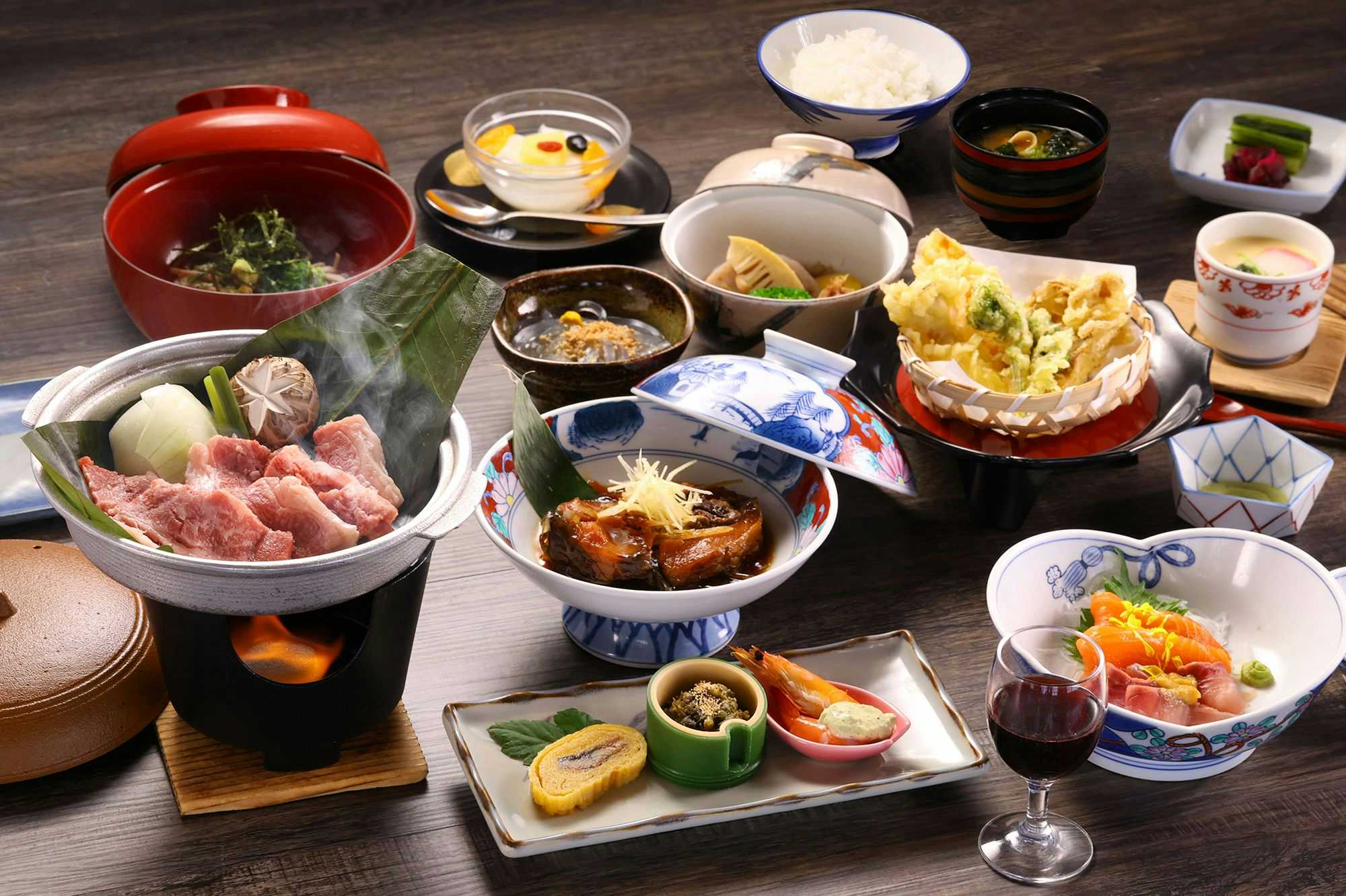 Suwakoen Inn by Lake Suwa with a seasonal Japanese dinner arranged across colorful bowls.