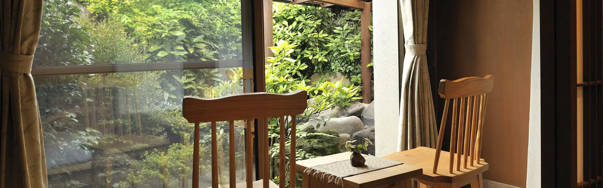 Oyado Kaikatei with this scene, where its window-side table looks directly into a leafy garden.