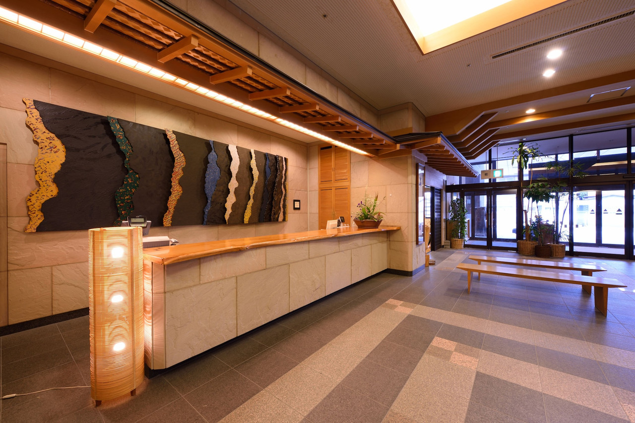 Open lobby with wood accents and sea views.