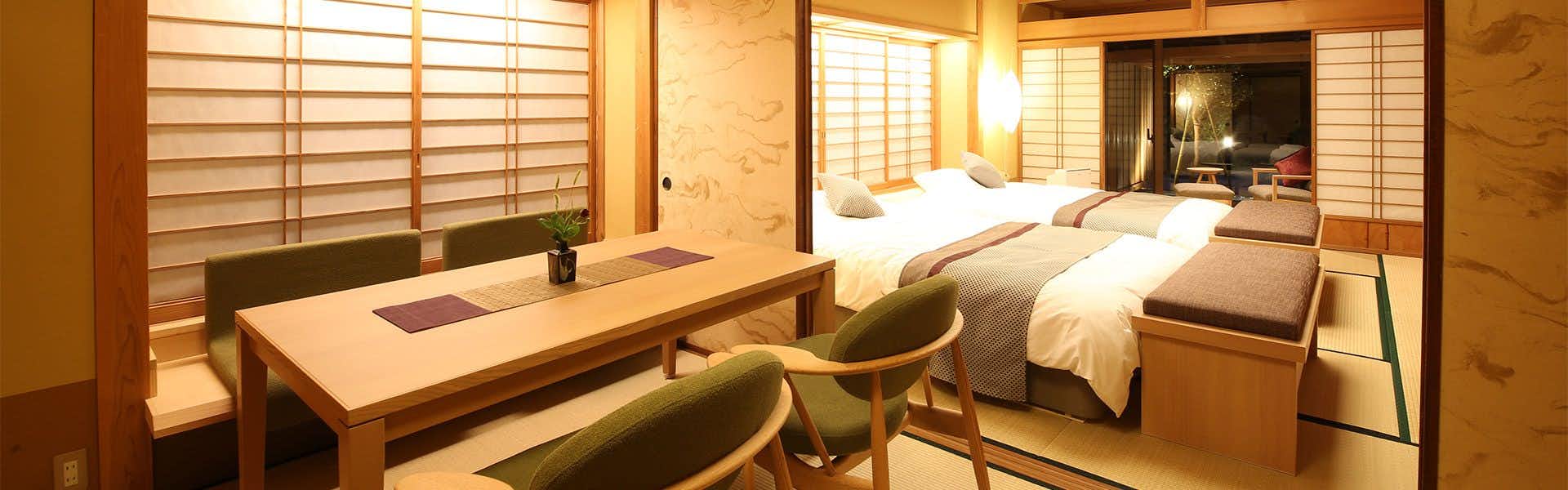 Saginoyu Inn with a modern guest room with twin beds and timber desk.