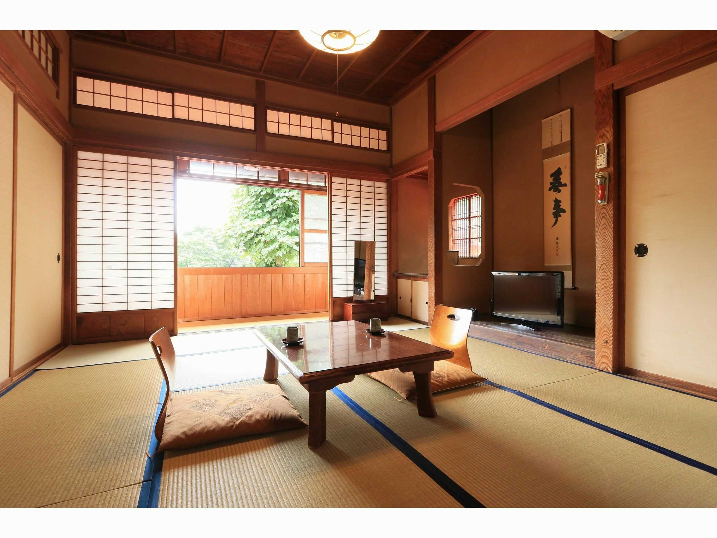 Senninburo Kanaya Ryokan with a bright tatami room opening toward a private balcony.