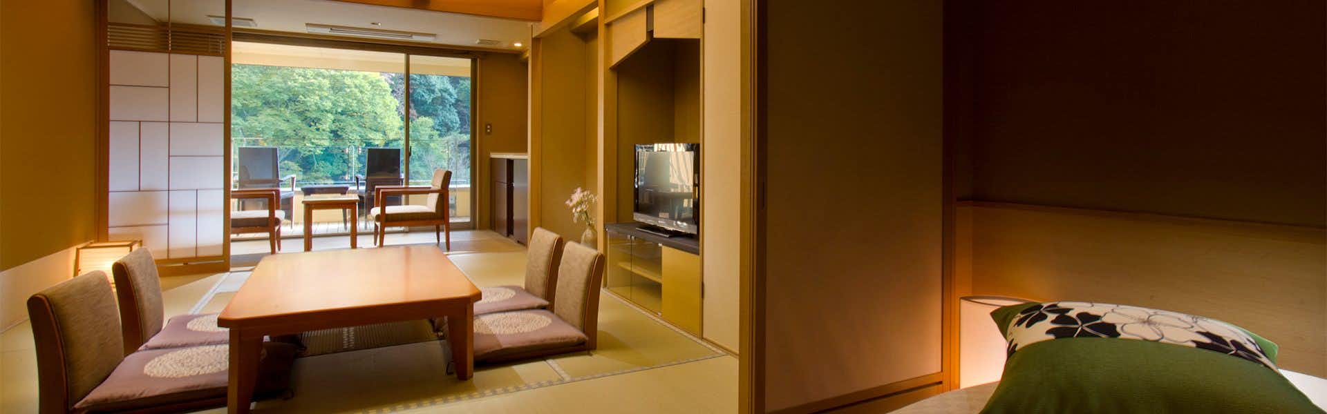 Shimoda Rendaiji Onsen Seiryuso with a low table, floor chairs, shoji panels, and green window view