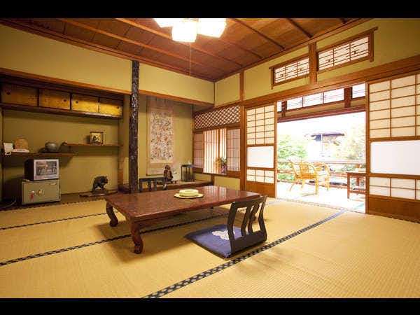 Masugen Ryokan with a bright traditional room with low table and garden doors.