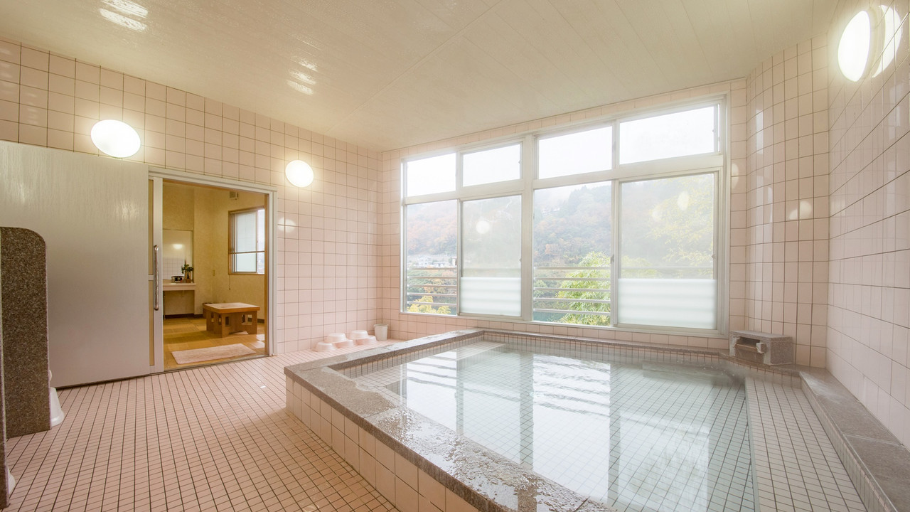 Indoor bath in a tiled room.