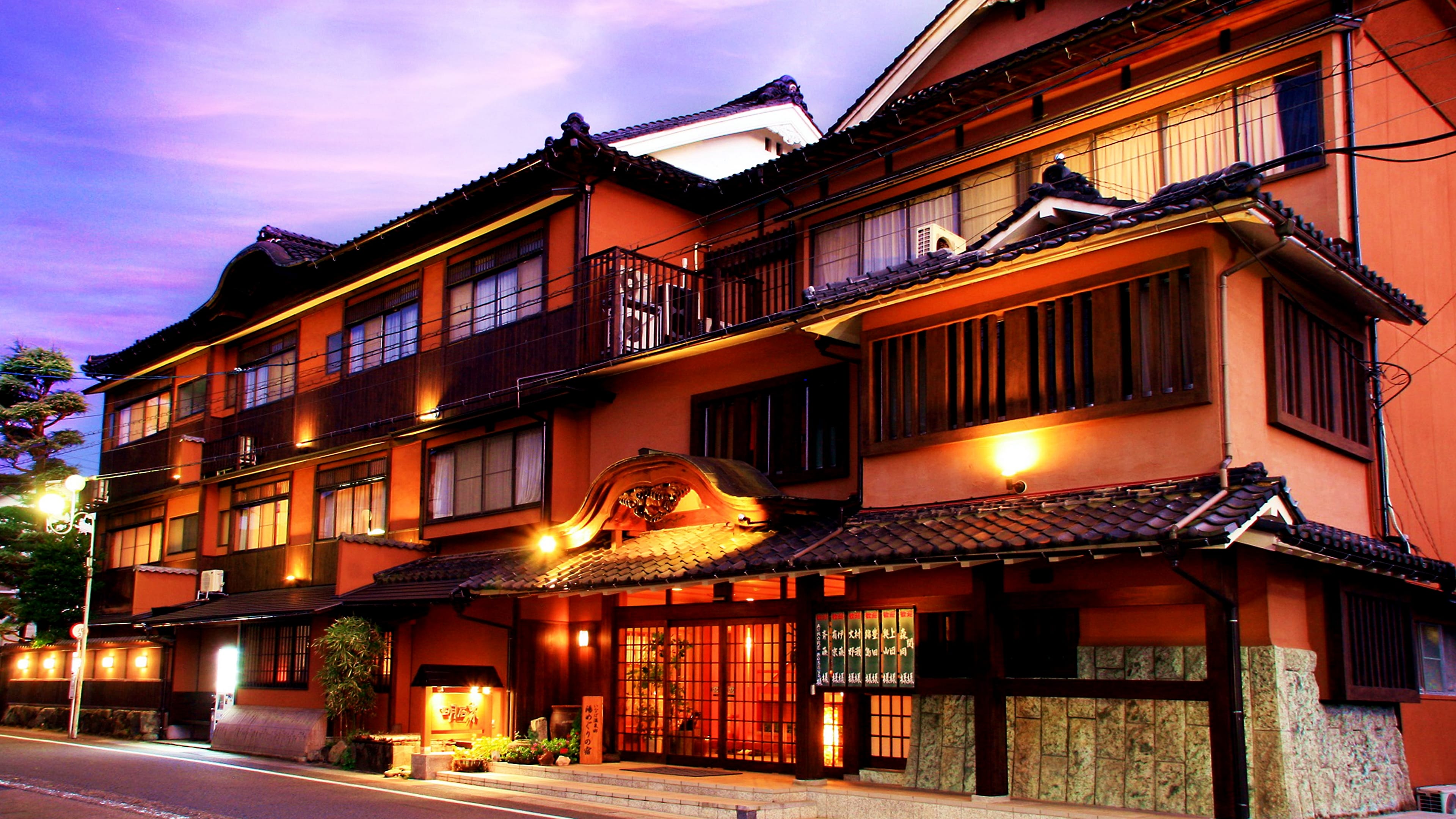 Exterior of a traditional ryokan beside the coast.