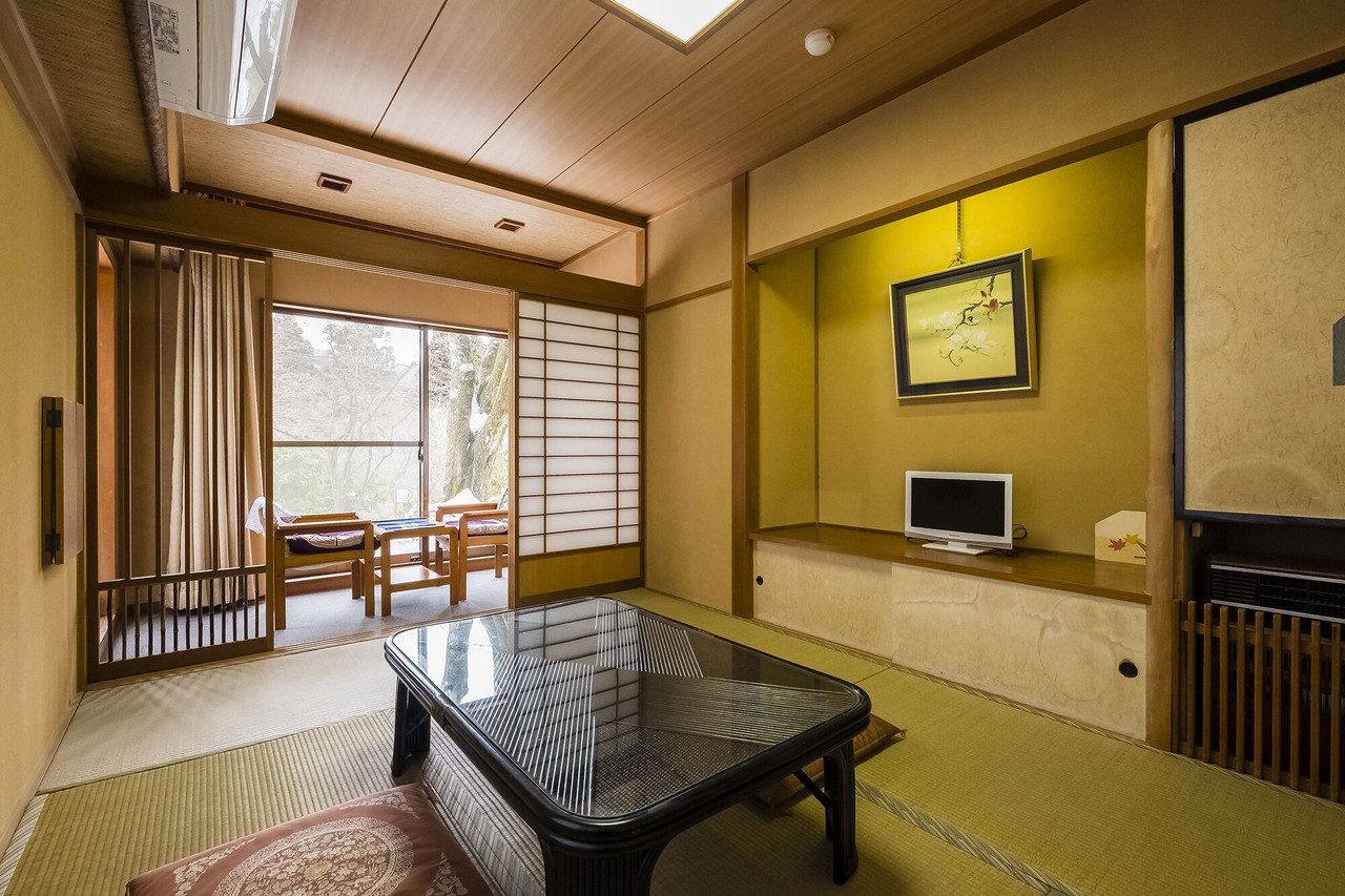 Guest room with seating and a wide window.