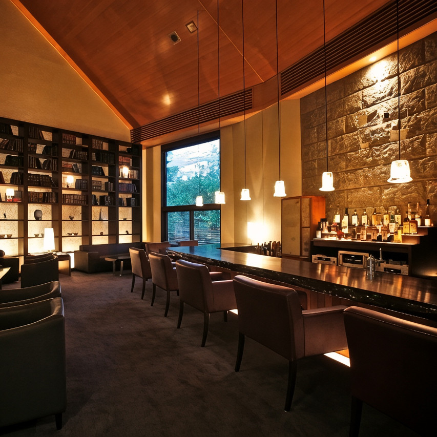 A dining room with pendant lights and a bar.