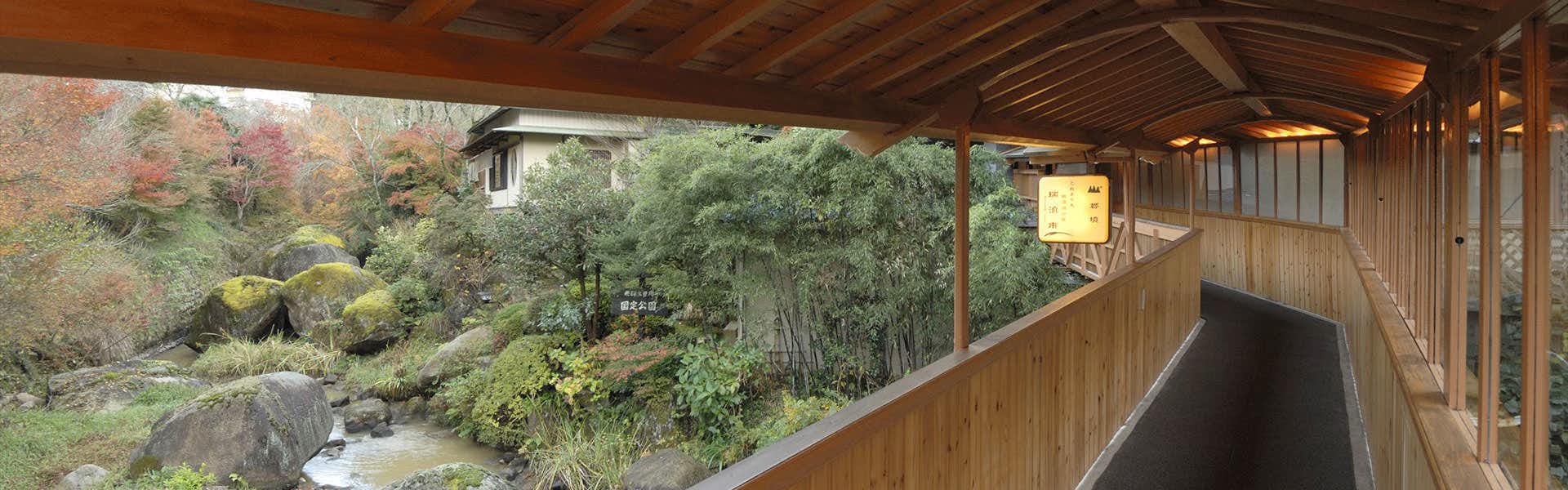 Gio Onsen Ryosan with a covered timber corridor overlooking the landscaped garden.