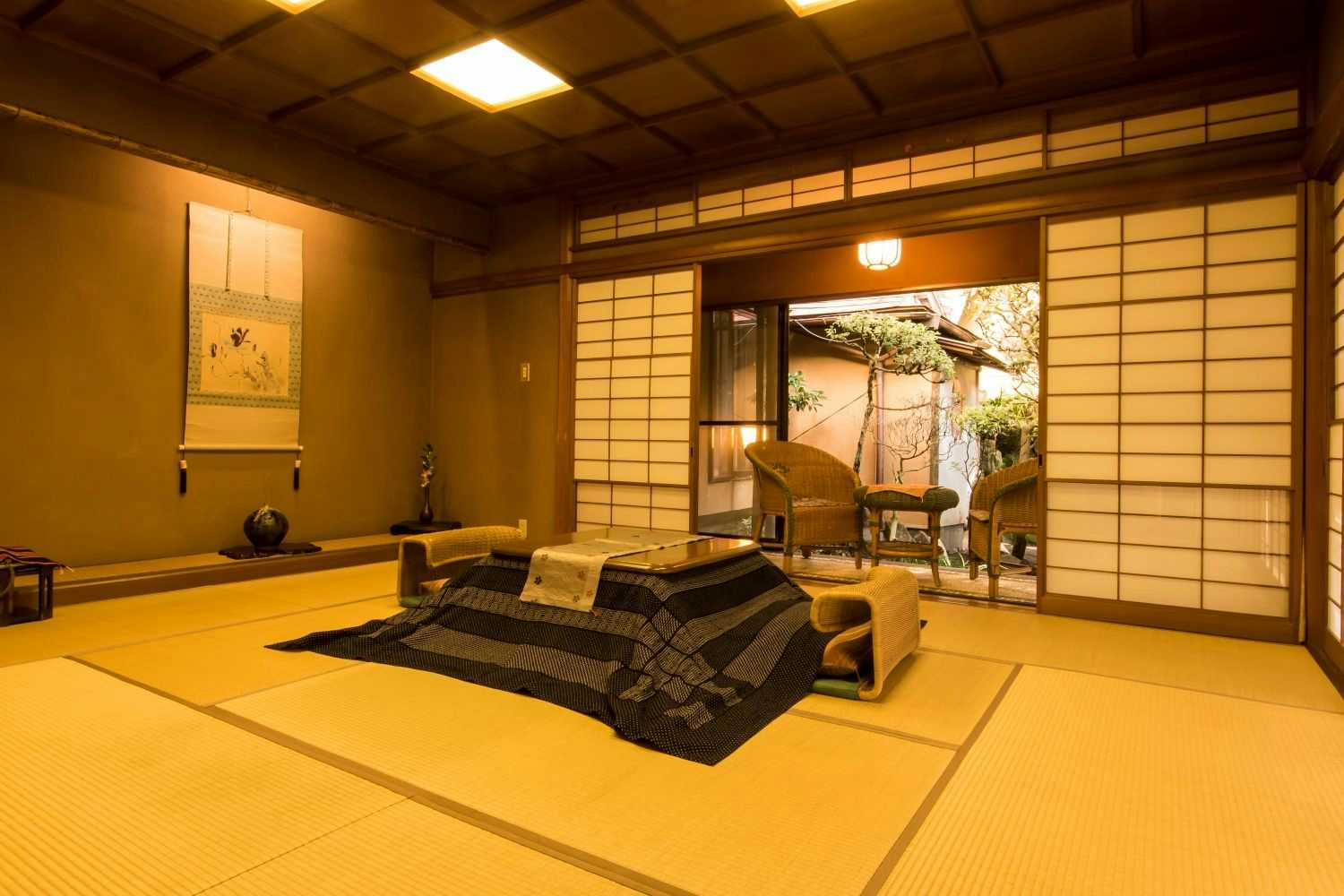 A quiet tatami room beside a private stone bath.