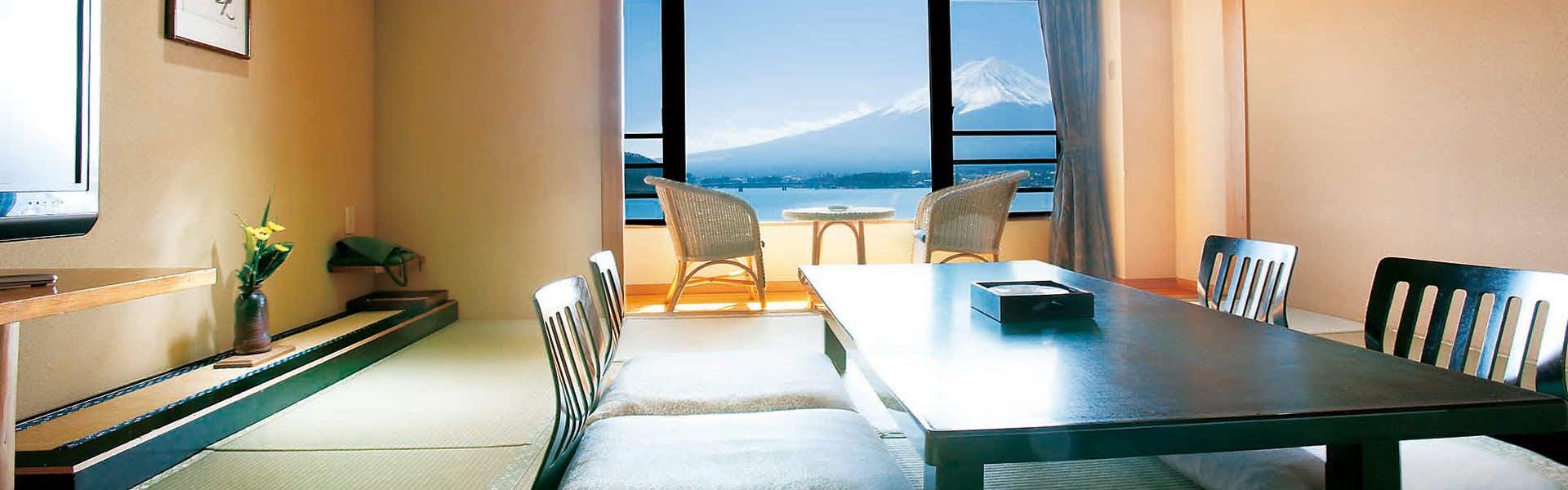 Shuhokaku Kogetsu a tatami room with a low table and mountain windows.