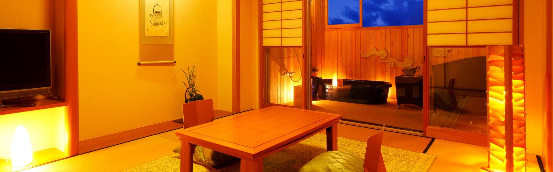 The Kouragi a tatami room adjoining a wood-paneled bathing area.
