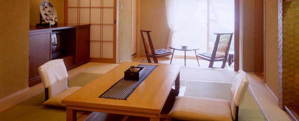 Kappo Ryokan Momiya with a bright tatami room opening toward balcony windows.