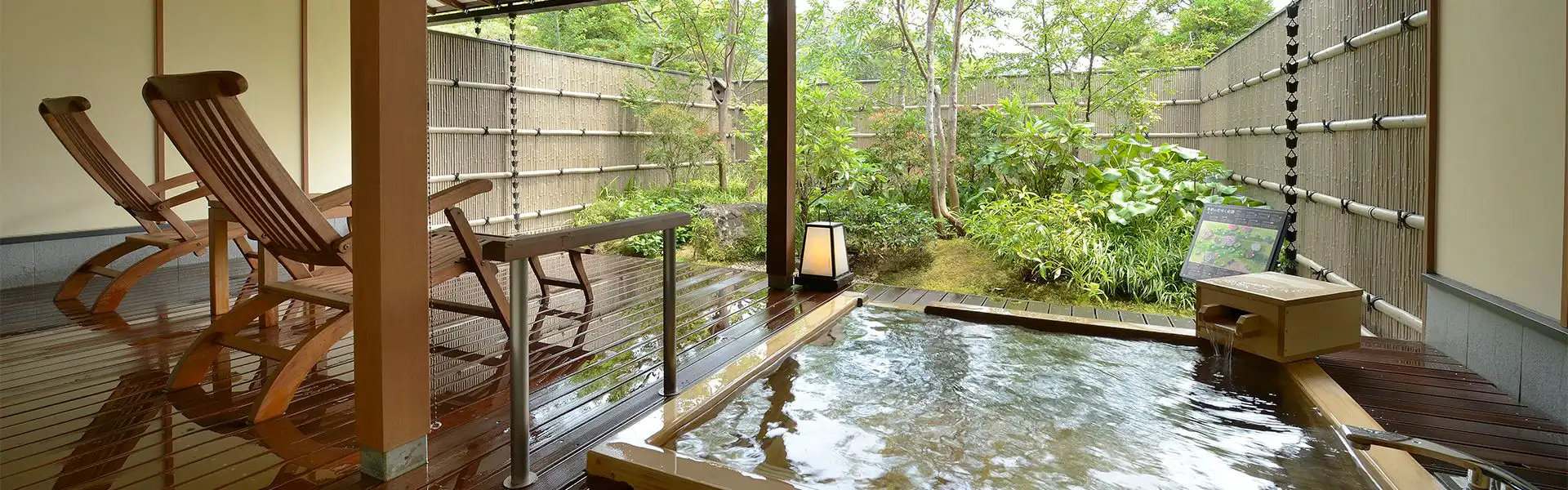 Satoyama Villa Shimoda Central Hotel with this scene, where its open-air bath sits beside a bamboo screen and leafy garden.