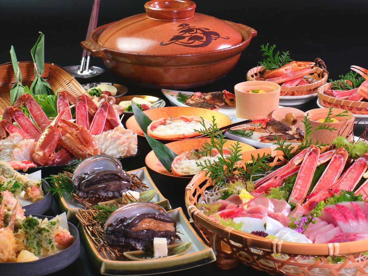 Yuhigaura Onsen Ryokan Katou with a sashimi and crab feast surrounding a whole red fish.