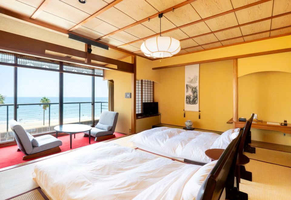 Guest room with beds and a sea view.