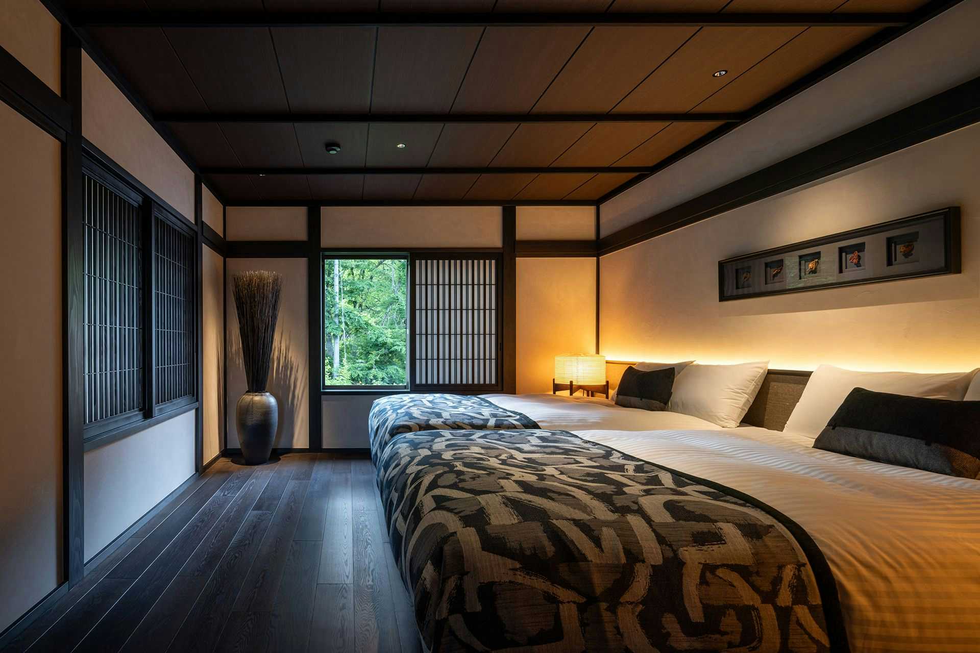 Osawayama Onsen Osawakan twin beds in a dark wood-trimmed room with a narrow window