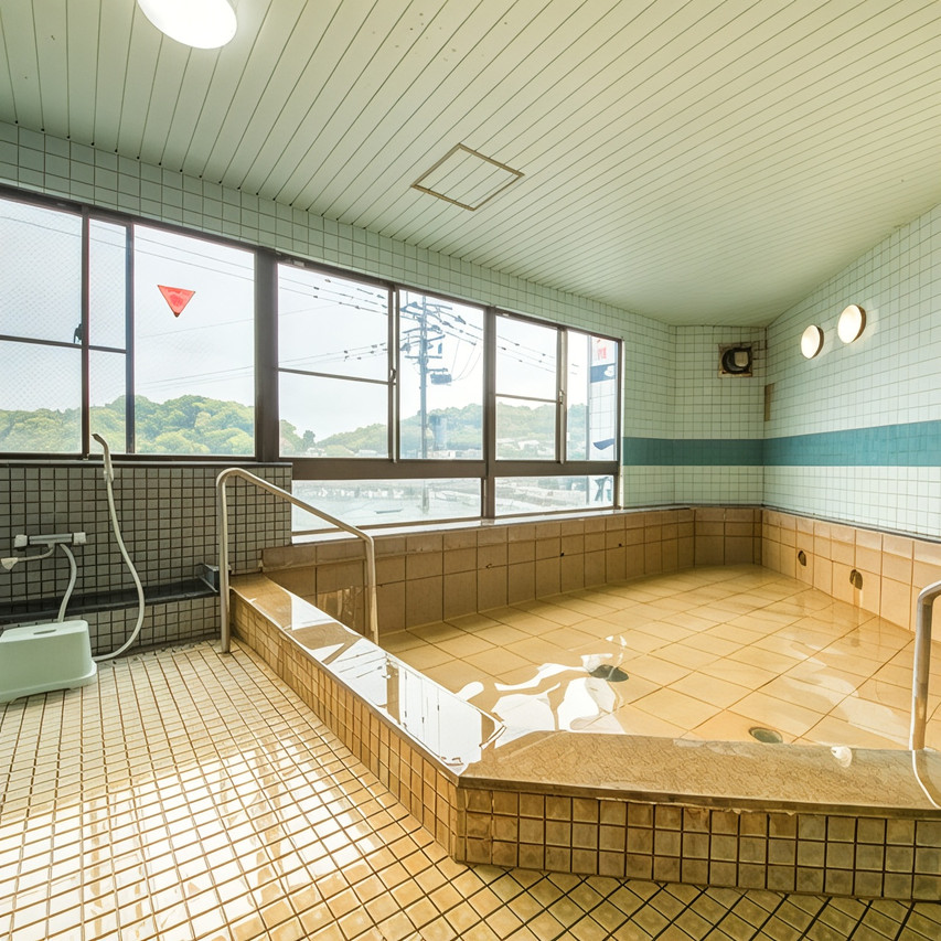 A tiled bath with windows.