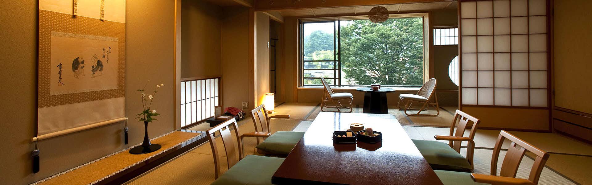 Oyado Tamaki with a refined tatami room with low table and garden window.
