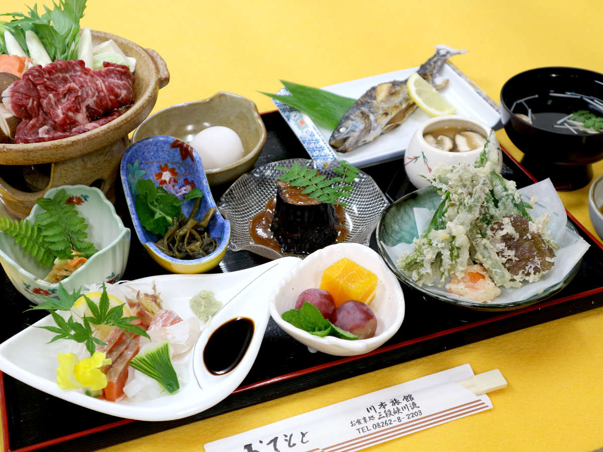 A meal arranged with sashimi, vegetables, and assorted dishes.
