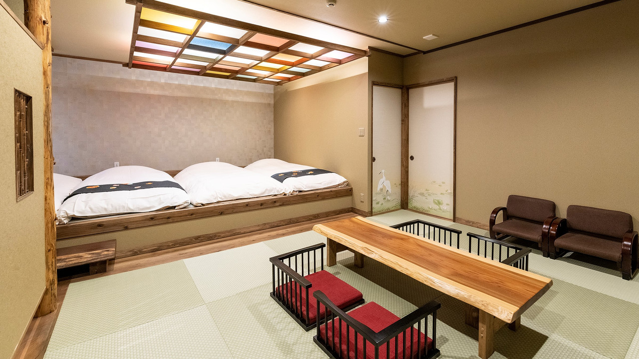 A bedroom with futons and a patterned wall.