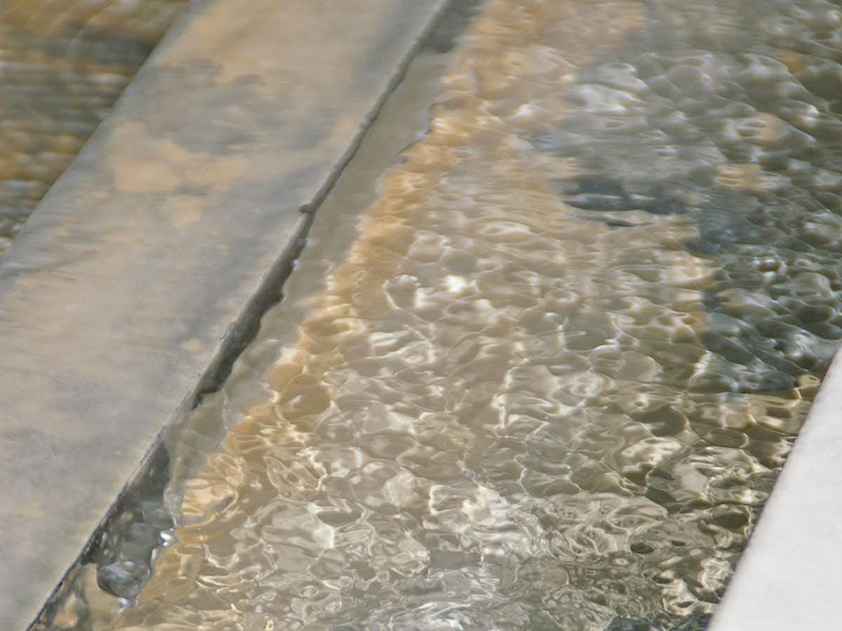 Hasedera Yumoto Itaniya with this scene, where clear water ripples over pale stones along the edge of a bath.
