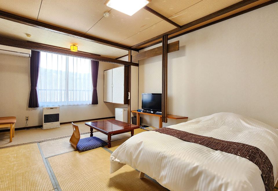 A tatami guest room with a bed and low table.